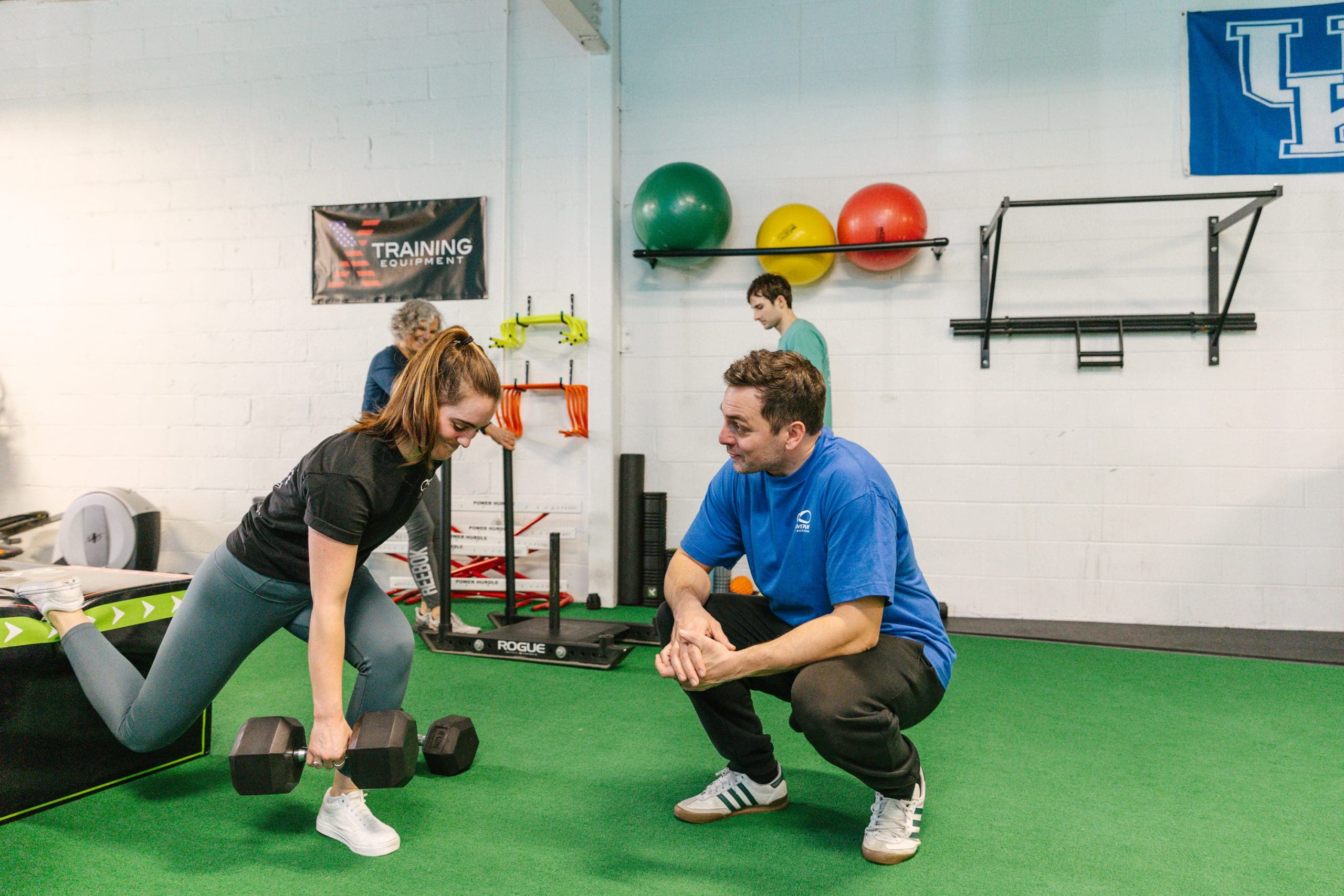 TrainMovePlay man coaching a woman doing a lunge
