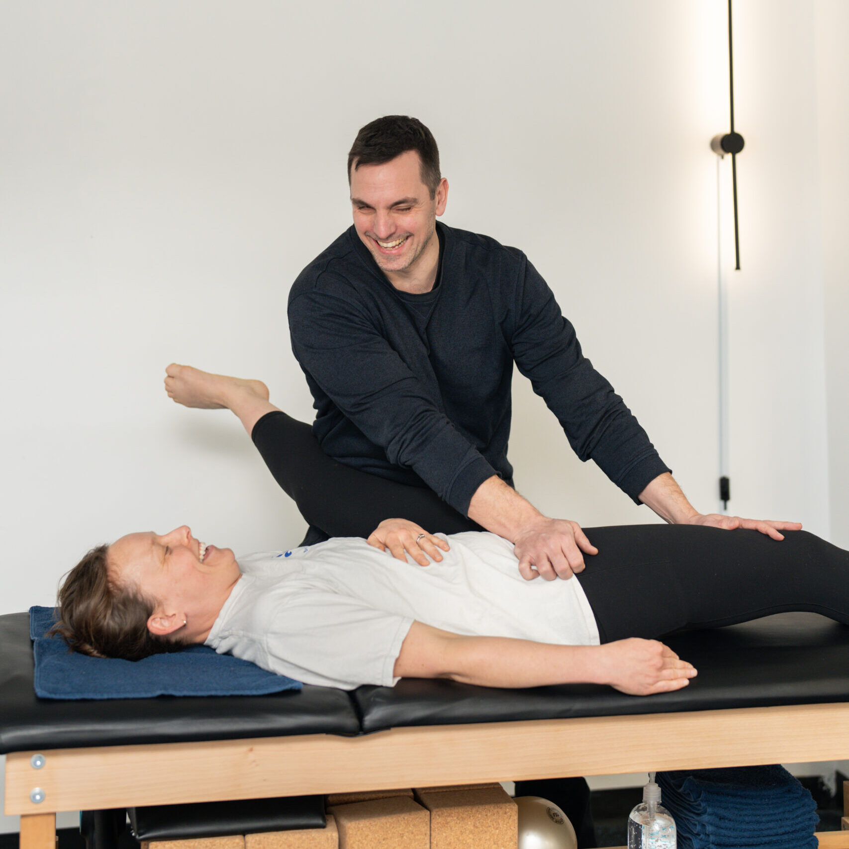 Sarah & Martin Man stretching a woman on a table